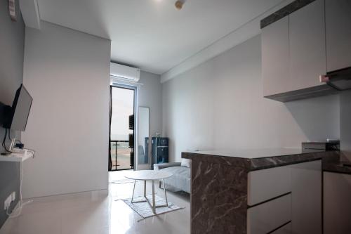 a kitchen with a counter and a table in a room at Palam Mansion at Apartment One Residence in Batam Center