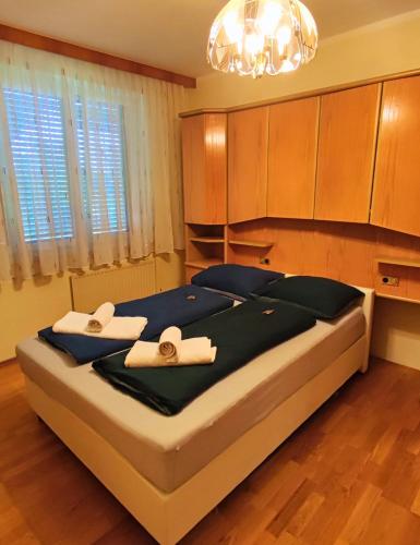 a bedroom with a large bed with towels on it at Apartment inklusive Parkplatz in Velden am Wörthersee