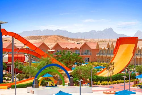 a water park with a slide and a roller coaster at Neverland City Hurghada - Pickalbatros in Hurghada