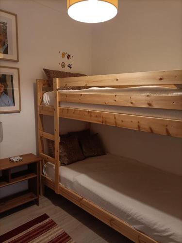 a bedroom with two bunk beds and a lamp at Akademia House - Santarém in Santarém
