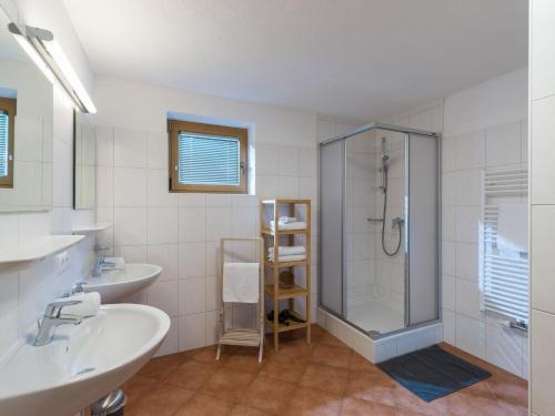 a bathroom with two sinks and a shower at Appartements Wanner in Gerlos