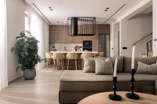 a living room with a couch and a kitchen at Gioarde Luxury Villa with Private Pool & Sea Views, by ZanteWize in Akrotiri