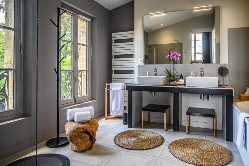 a bathroom with two sinks and a large mirror at Clos 1906 in Saint-Émilion