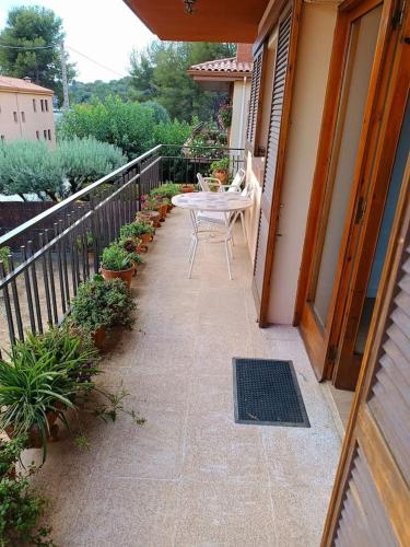 a patio with a table and chairs on a balcony at Secrets of Montserrat in El Bruc