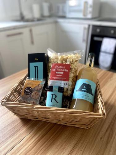 a basket filled with products on a table at Modern City Centre Flat in Norwich