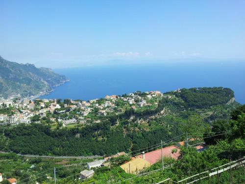 a town on a hill with a body of water at B&B Oliva in Scala