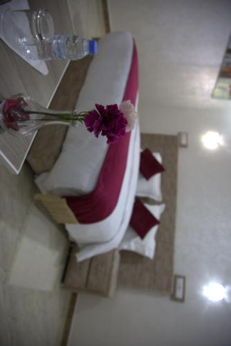 a vase with a flower on top of a bath tub at Dakhla Guest in Dakhla
