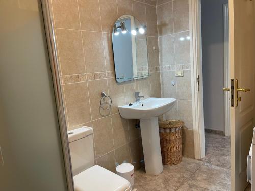 a bathroom with a sink and a toilet and a mirror at Bahia I in Puerto de la Cruz