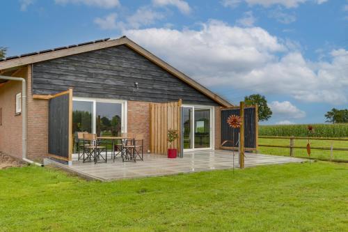 a small house with a deck and patio at Pronkserf in Lemelerveld