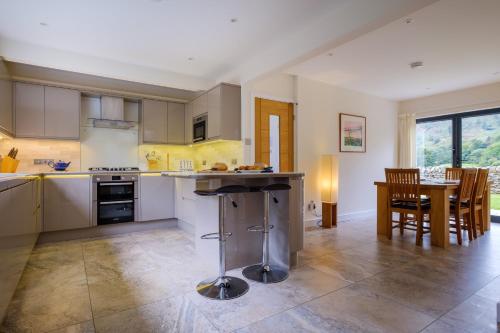 a kitchen and dining room with a table and chairs at The Old Police House in Grasmere