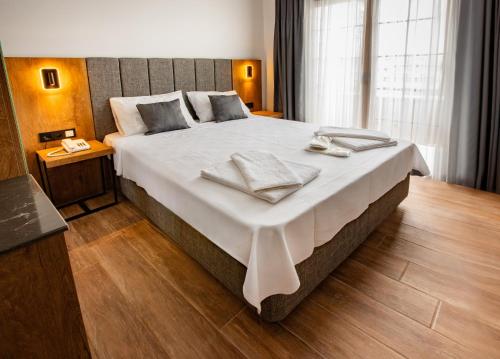 Ένα ή περισσότερα κρεβάτια σε δωμάτιο στο Grand Business Hotel