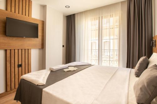 Ένα ή περισσότερα κρεβάτια σε δωμάτιο στο Grand Business Hotel