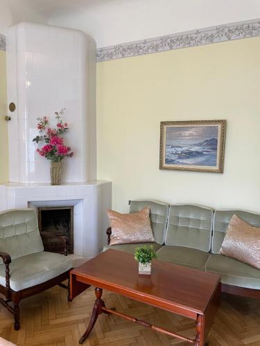 a living room with a couch and a table at Green Villa in Pärnu
