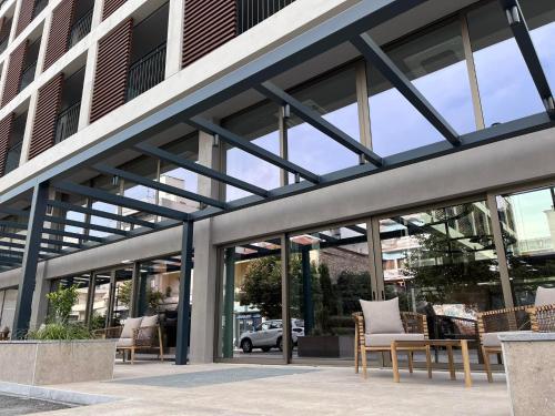 a group of chairs sitting outside of a building at Magnes Hotel in Volos