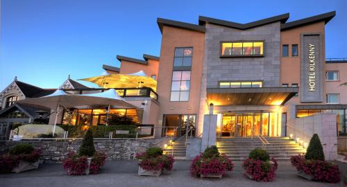 a large building with flowers in front of it at Hotel Kilkenny in Kilkenny
