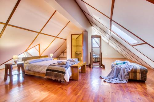 a attic bedroom with two beds and a mirror at Lady Grey Walk Mcgregor Cottage in McGregor