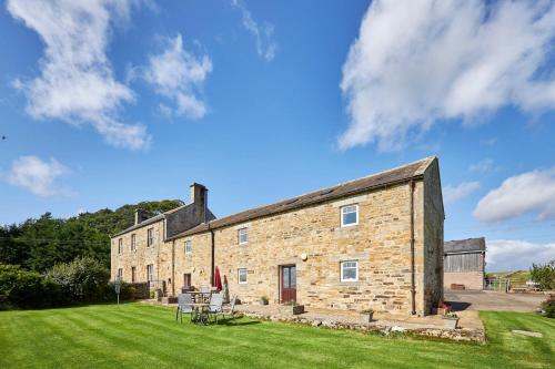 a large brick building with a grassy yard at Host & Stay - Carr Edge in Newbrough