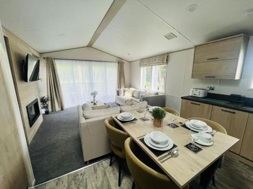 a kitchen and living room with a table and chairs at Hideaway Retreat with Hot Tub in York