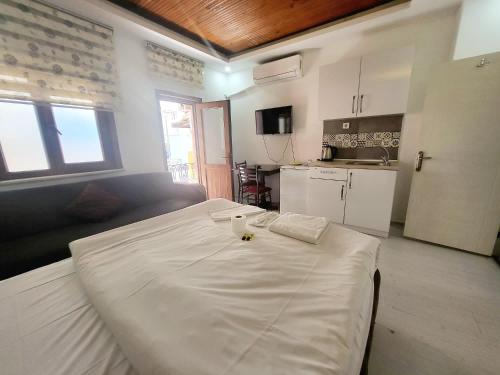 a large white bed in a room with a kitchen at taksim 34 apart istanbul in Istanbul