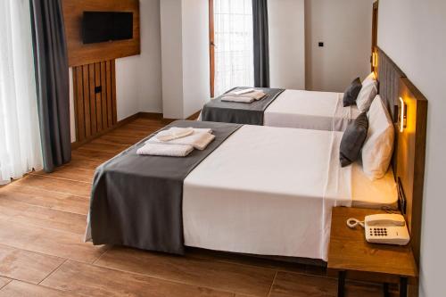 Ένα ή περισσότερα κρεβάτια σε δωμάτιο στο Grand Business Hotel