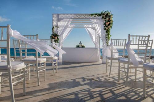 a wedding ceremony on the beach with chairs and an altar at Viva Dominicus Beach by Wyndham, A Trademark All Inclusive in Bayahibe