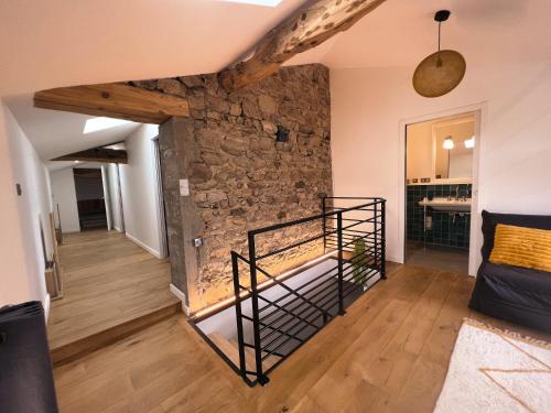 a room with a stone wall and a bunk bed at Bulles en Beaujolais in Fleurie