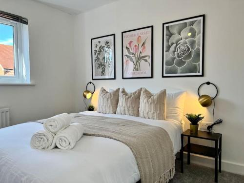 a bedroom with a white bed with towels on it at Luxury Newly Renovated House 