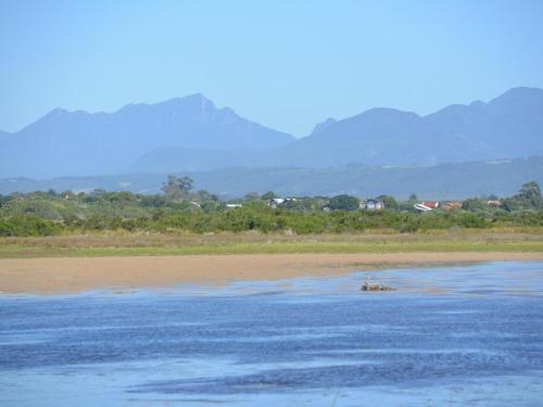 an elephant in the water with mountains in the background at Water's Edge in Sedgefield