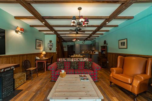 a living room with a couch and a table at Black Sheep Hotels Cabins in Spean Bridge