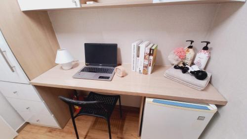 a desk with a laptop computer on top of it at Haechi Stay GuestHouse - For foreigners only in Seoul