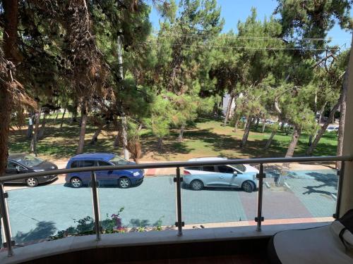 a balcony with cars parked in a parking lot at Çamlıkta deniz manzaralı 5+1 dubleks in Didim