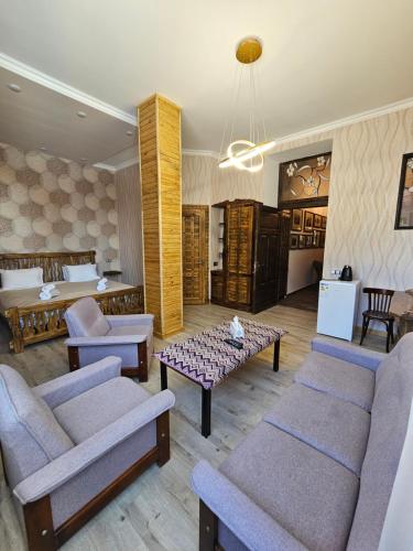 a living room with two couches and a table at Via Gyumri in Gyumri