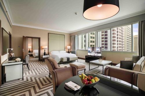 a hotel room with a king bed and a living room at Al Maha Arjaan by Rotana in Abu Dhabi