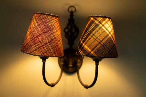 a pair of lights hanging from a wall at Black Sheep Hotels Cabins in Spean Bridge