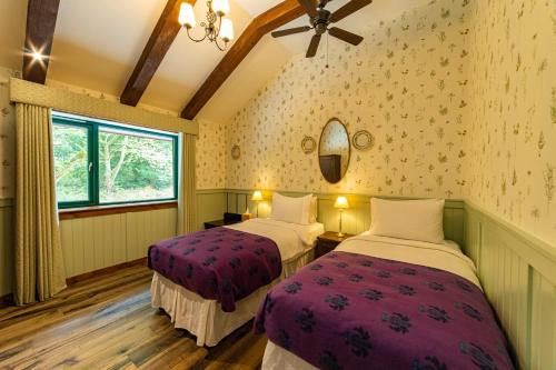 a room with two beds and a window at Black Sheep Hotels Cabins in Spean Bridge