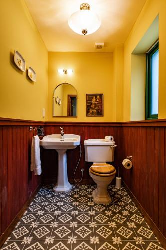 a bathroom with a toilet and a sink at Black Sheep Hotels Cabins in Spean Bridge