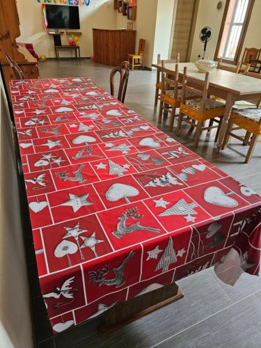 a table with a red blanket on top of it at Acerra's Villa in Nola
