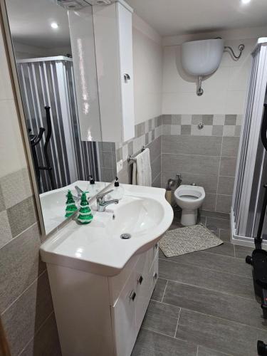 a bathroom with a sink and a toilet at Acerra's Villa in Nola
