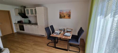 a dining room table and chairs in a kitchen at Ferienwohnung Familie Eder in Schönberg