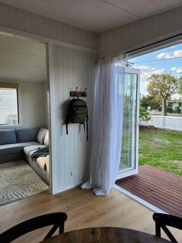 a living room with a couch and a sliding glass door at 40 On North. in Wondoan