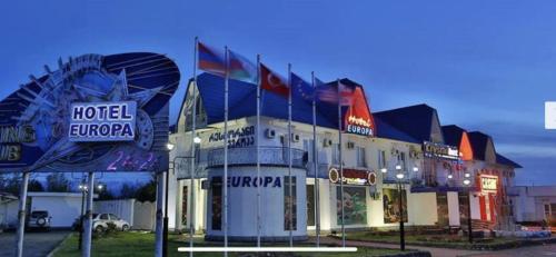 a hotel entrance with neon signs in front of it at Europa Hotel-Kutaisi in Kutaisi