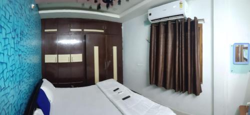 a bedroom with a bed and brown curtains at gratifiedhomestay in Visakhapatnam