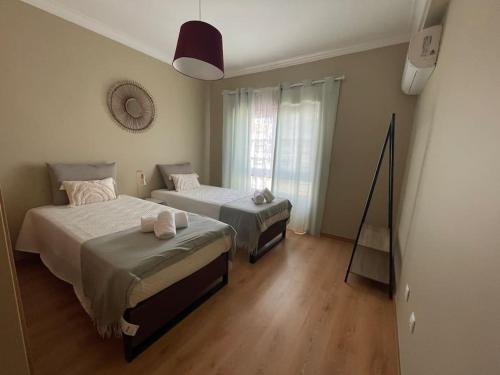 Postel nebo postele na pokoji v ubytování Charming Moita - APT 2 Quartos