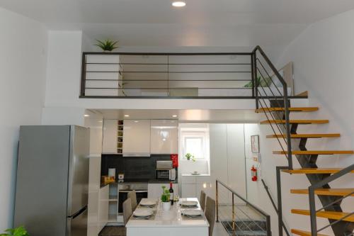 a kitchen with a staircase and a living room at Antiga adega in Óbidos