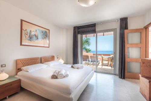 a bedroom with a bed and a view of the ocean at Romen 2-2 PENTHOUSE SEA VIEW & JACUZZI 2B in Palm-mar