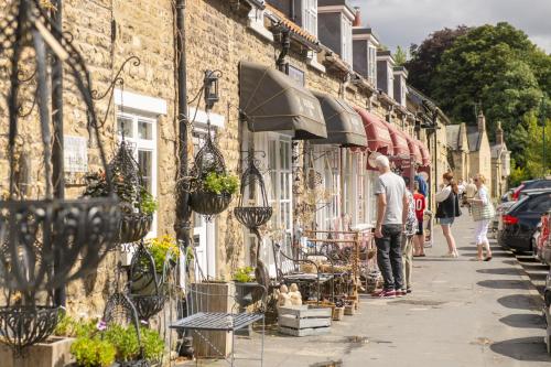 a group of people walking down a street at Church Farm in Wilton