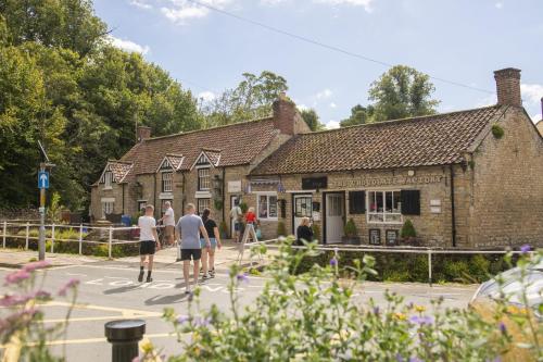 a group of people standing outside of a building at Church Farm in Wilton