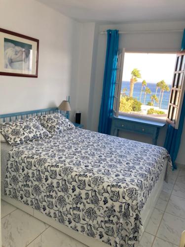 a bedroom with a bed with a view of the ocean at Apartamento Verena in Puerto del Carmen