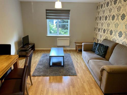 a living room with a couch and a table at May Disc - Long Stay - Contractors in Bristol