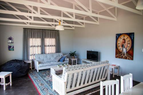 a living room with a couch and a clock on the wall at House on the Hill in Heidelberg